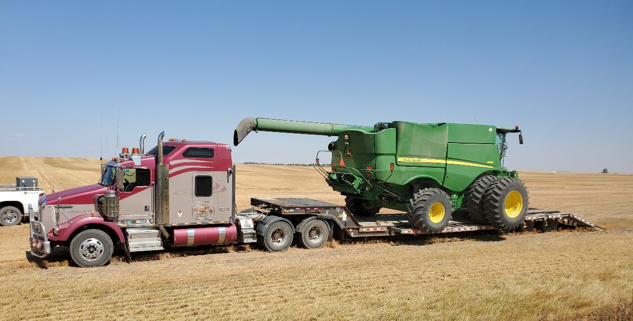 Move equipment with stepdeck trailer hauling by Terrock Trucking and Excavating in Alberta